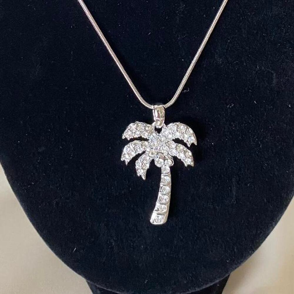 Silver tone palm tree pendant necklace with cubic zirconia on a snake chain